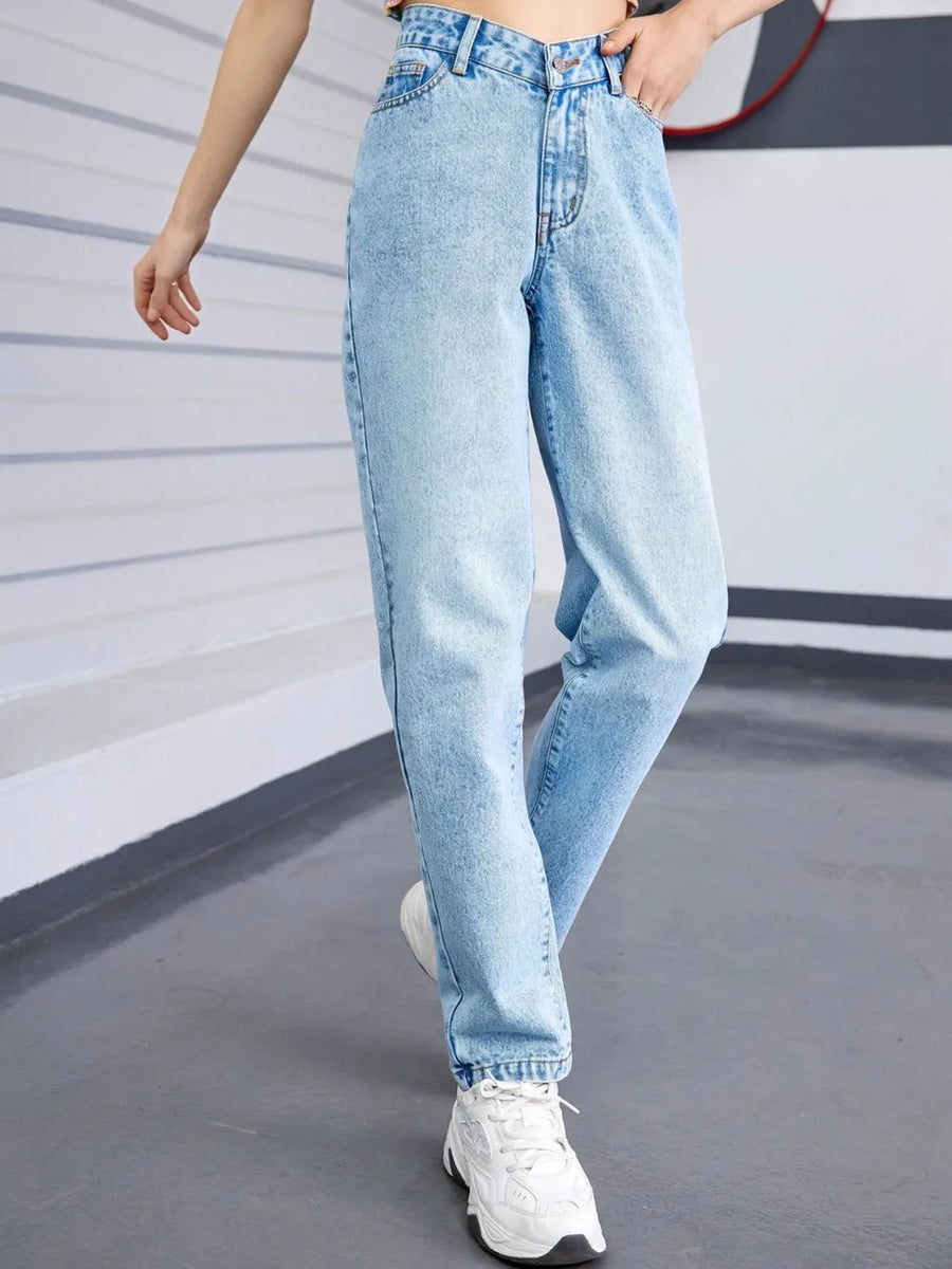 Light blue jeans worn by a person on a plain background