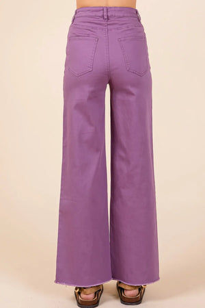 Purple bell-bottom pants on a beige background