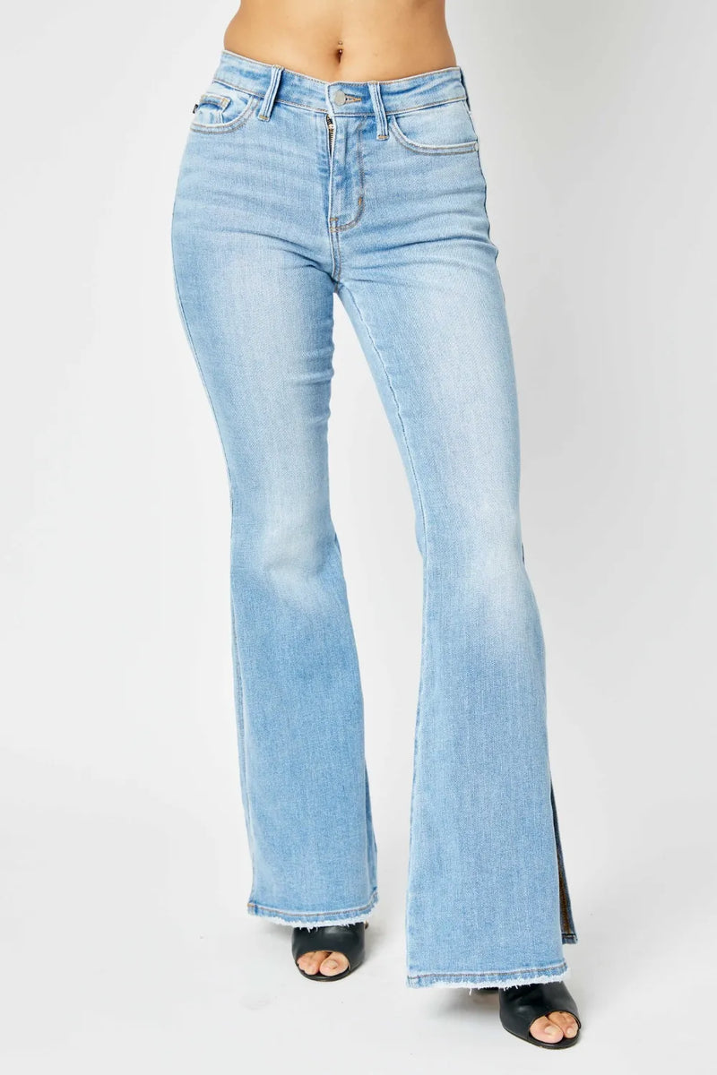 Light blue flared jeans on a white background