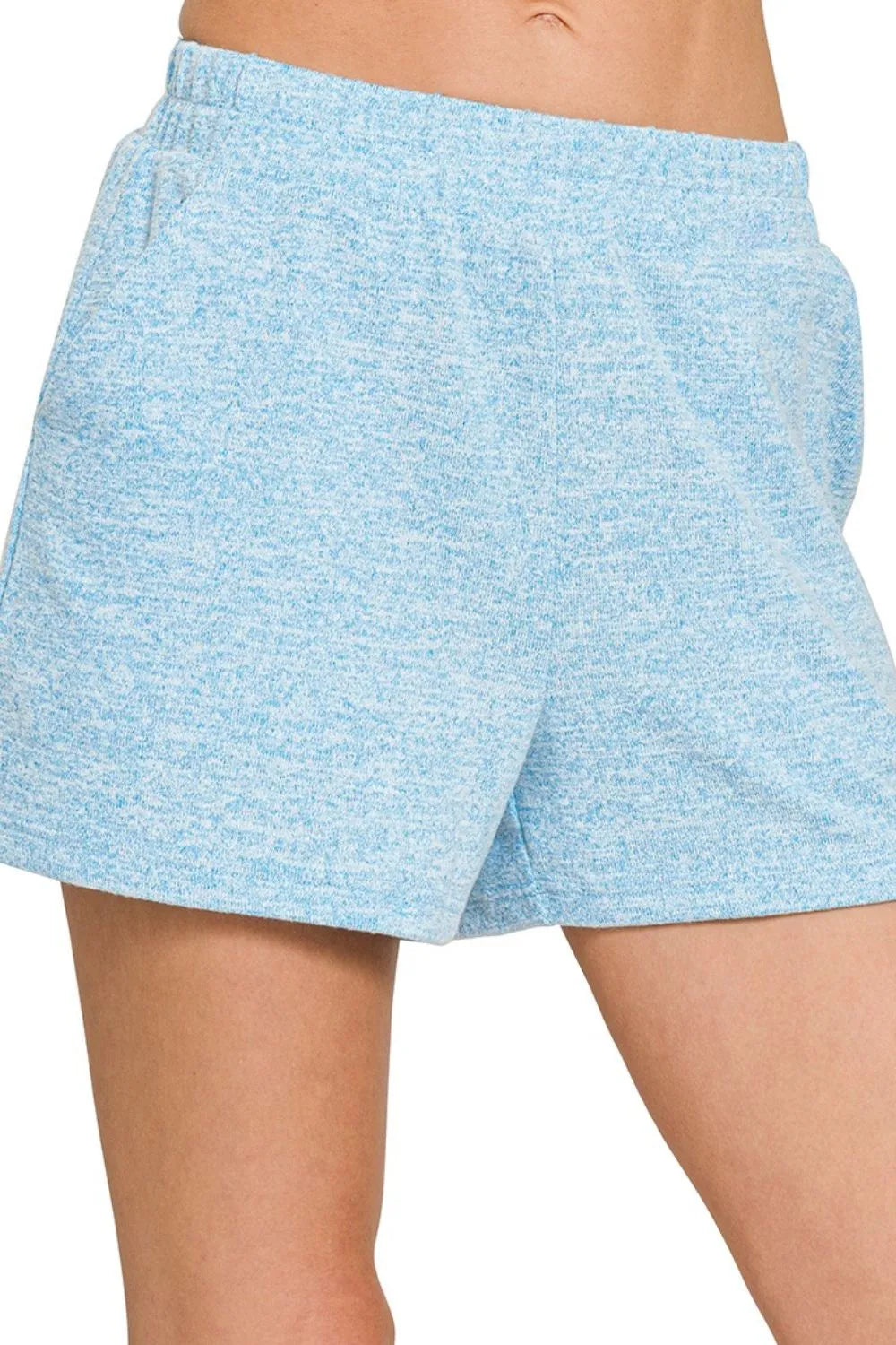 Light blue shorts worn by a person on a white background