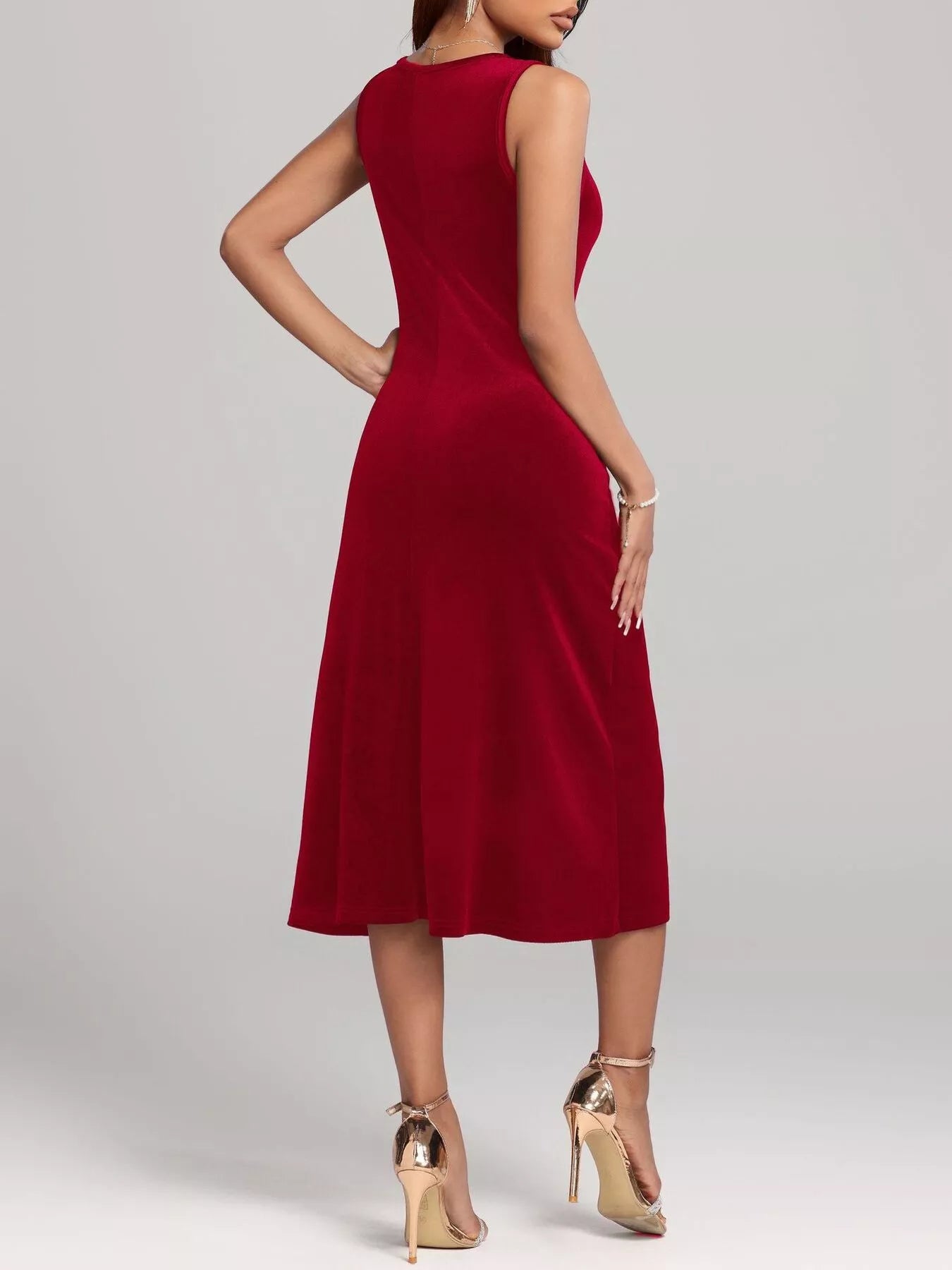 Red sleeveless dress worn by a model on a plain background