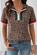 Person wearing a leopard print polo shirt with colorful trim and blue jeans.