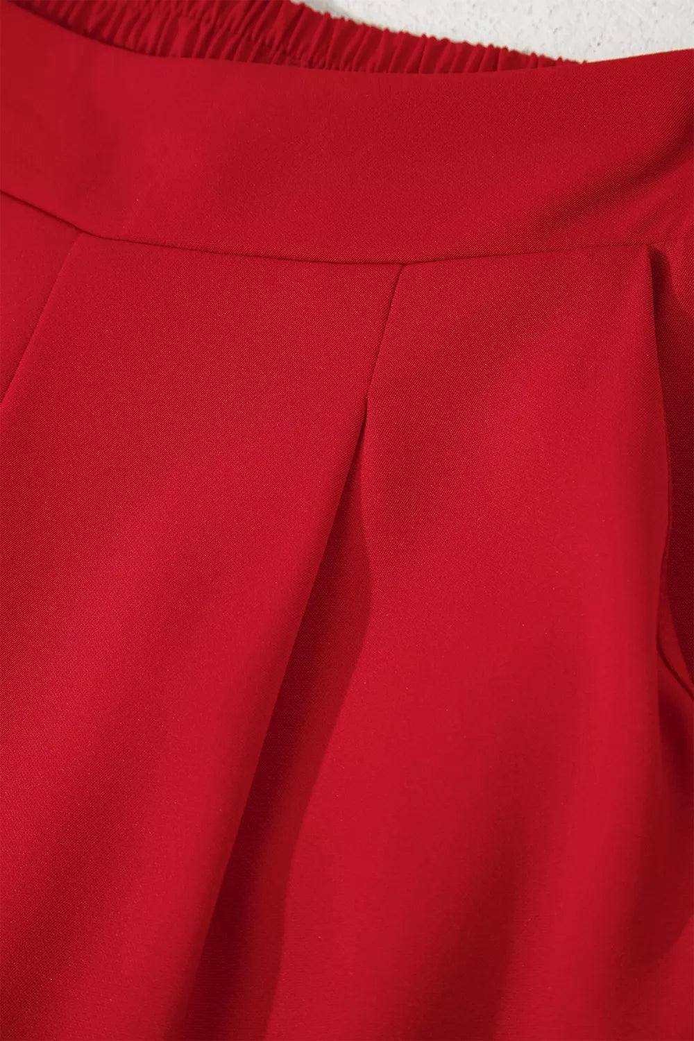 Close-up of a red garment with a textured edge.