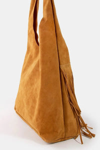 Brown suede handbag with fringes on a white background