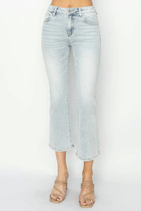 Light blue jeans worn by a person on a white background
