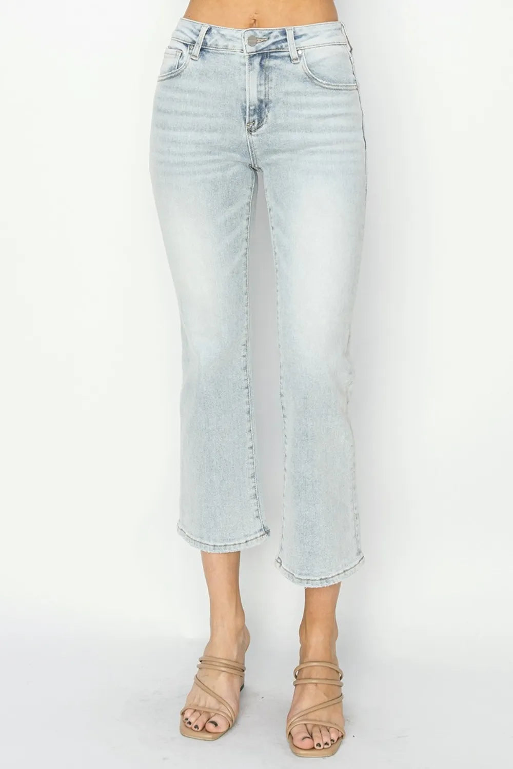 Light blue jeans worn by a person on a white background