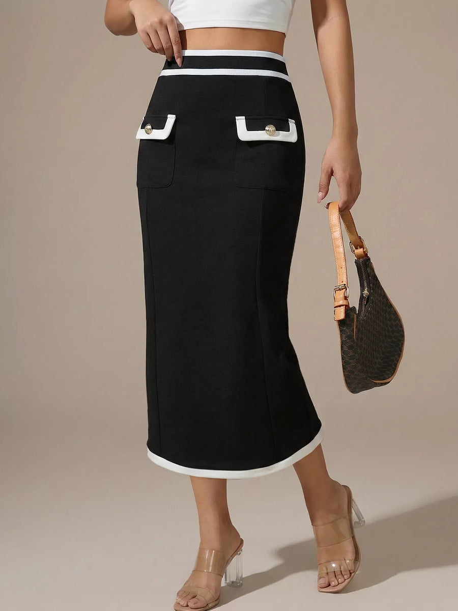 Person wearing a black skirt with white trim on a beige background