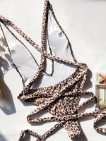 Leopard print bikini top on a white surface