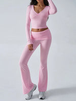 Person wearing a pink long-sleeve top and pants on a white background