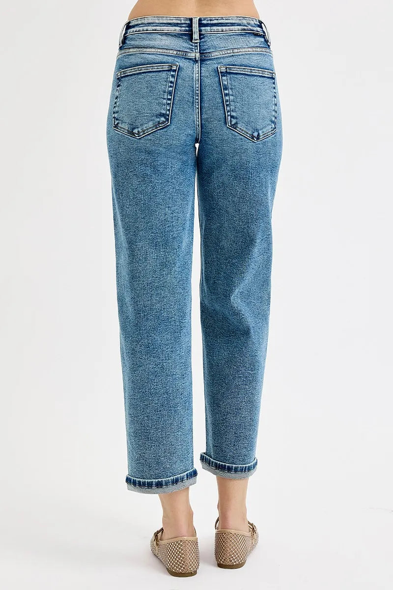 Blue jeans worn by a person on a white background