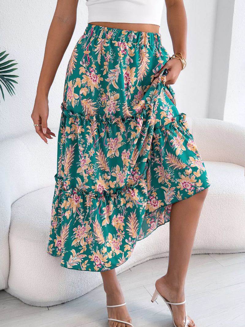 Person wearing a green floral skirt in a minimal indoor setting