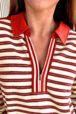 Close-up of a person wearing a red and white striped shirt with a red collar.