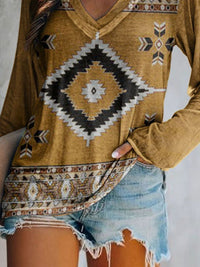 Mustard yellow hoodie with geometric pattern worn by a person, paired with denim shorts on a neutral background.