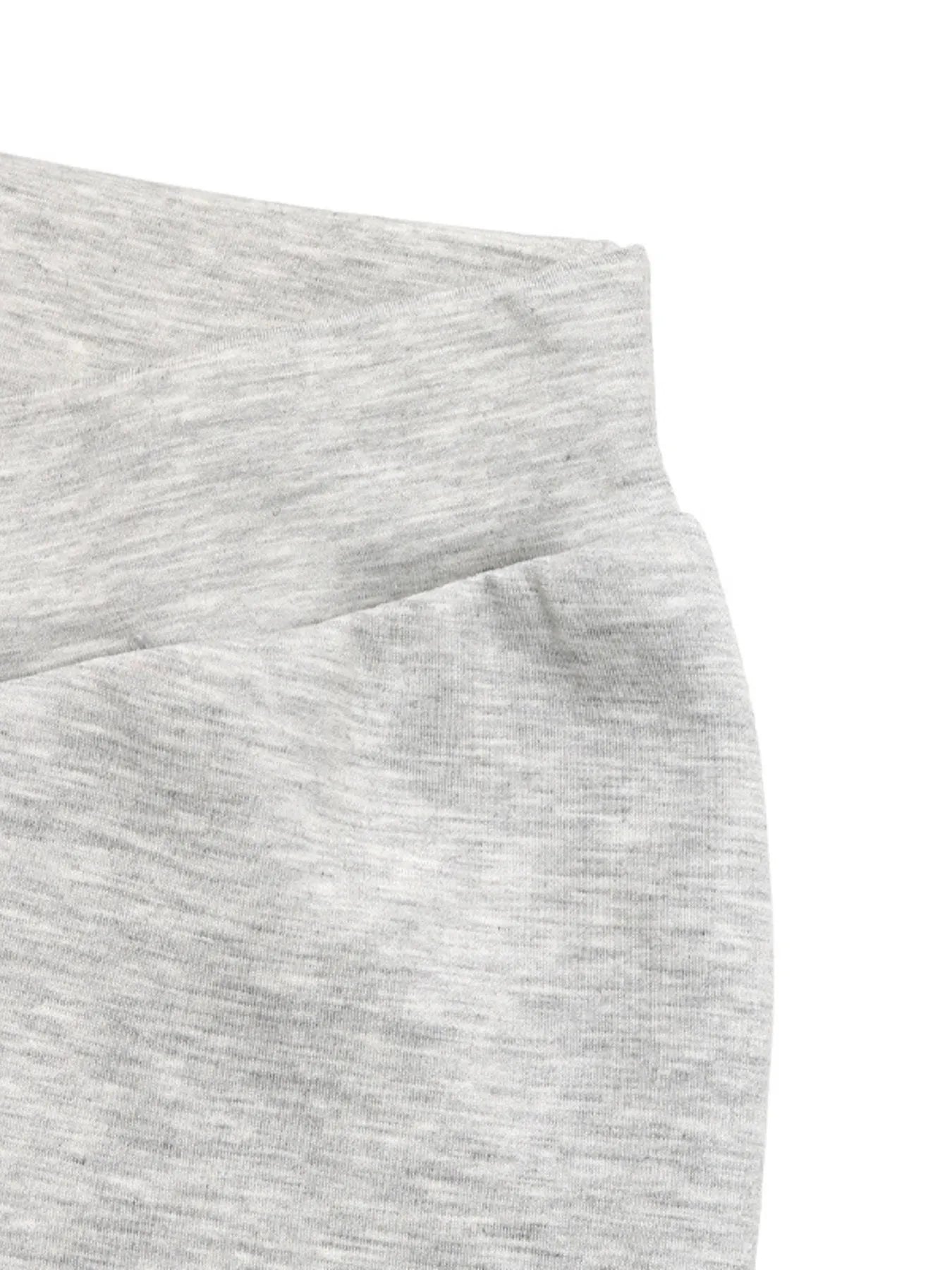 Close-up of gray sweatpants with a white background