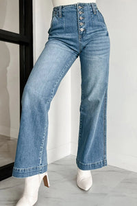 Blue jeans worn by a mannequin on a plain background