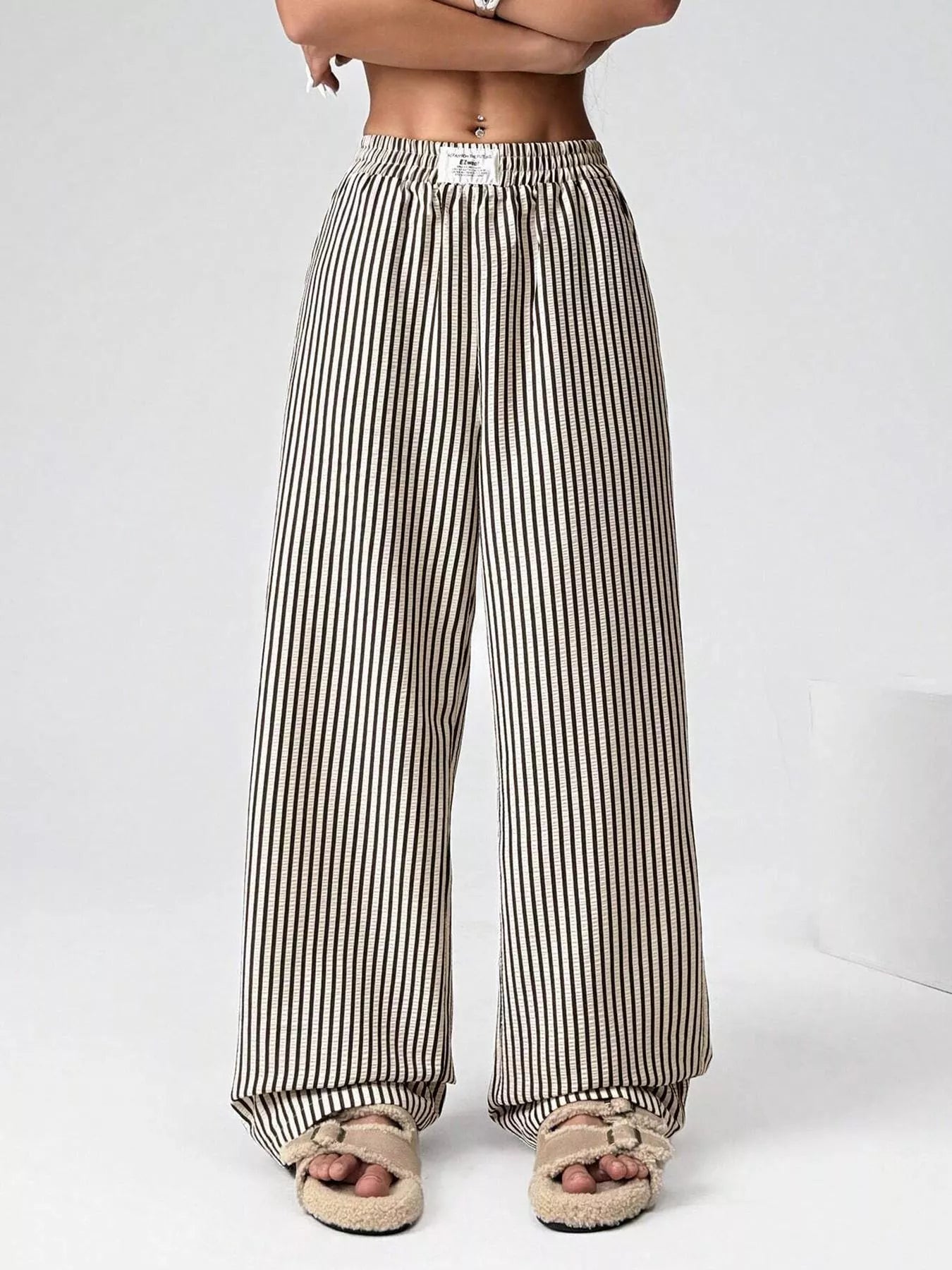 Striped wide-leg pants worn by a person on a white background