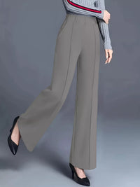 Gray wide-leg pants worn by a person on a gray background