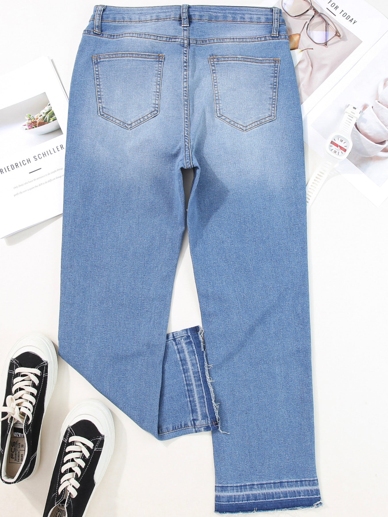 Light blue jeans with a casual cut on a white background