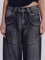 Person wearing black jeans on a plain background