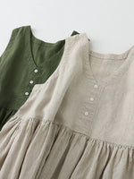 Two dresses, one green and one beige, with a plain background