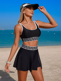 Woman in black sports outfit with white patterns on a beach
