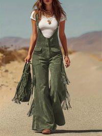 Person wearing green fringed overalls in a desert setting