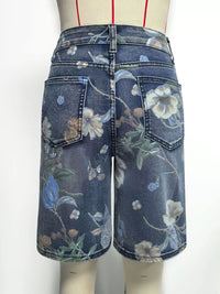 Denim skirt with floral pattern on a mannequin against a white background