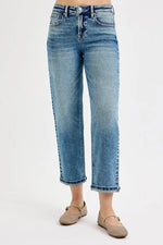 Light blue jeans worn by a person on a white background