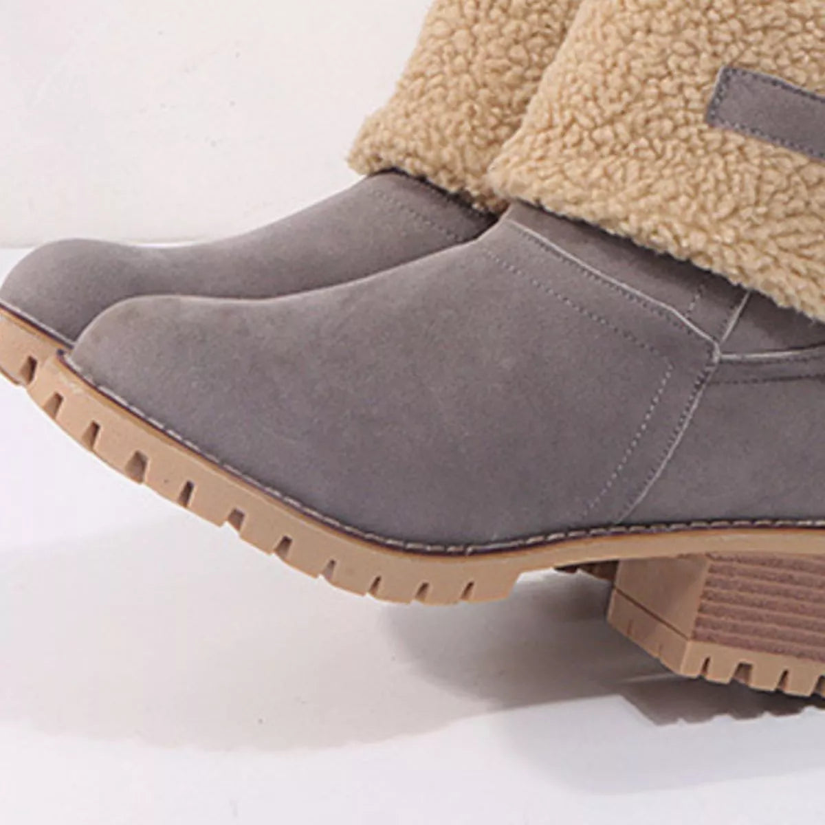 Gray slip-on boots with brown soles on a white background