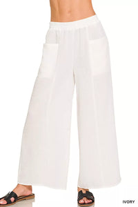 White wide-leg pants worn by a person on a white background