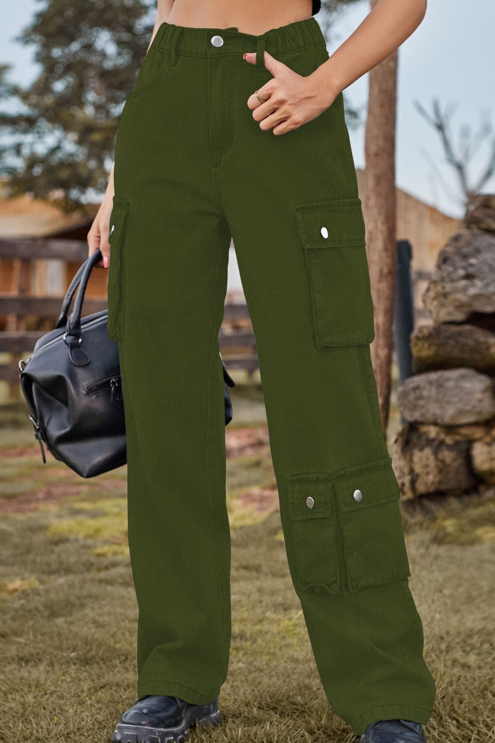 Person wearing green cargo pants with a blurred outdoor background