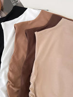 Close-up of a beige and brown sleeveless top on a white background