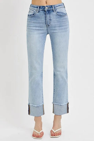 Light blue jeans with a rolled hem on a white background