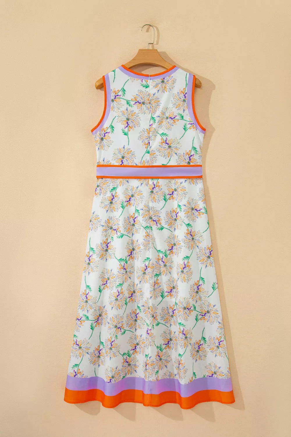 Floral dress with colorful trim on a beige background