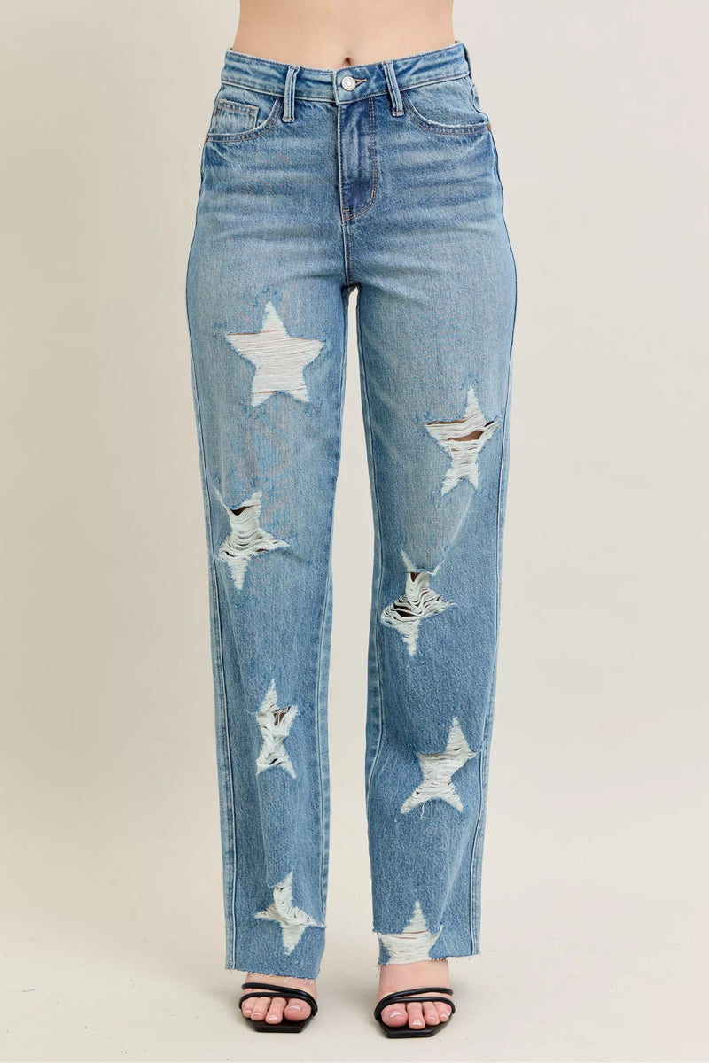 Blue jeans with star patterns on a plain background