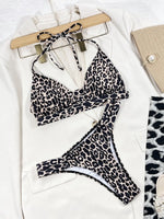 Leopard print bikini set on a hanger with a white background