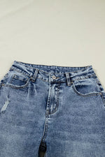 Pair of blue jeans on a light gray background