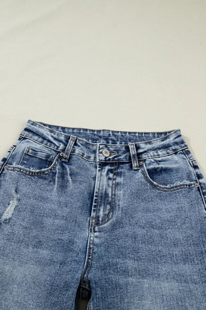 Pair of blue jeans on a light gray background