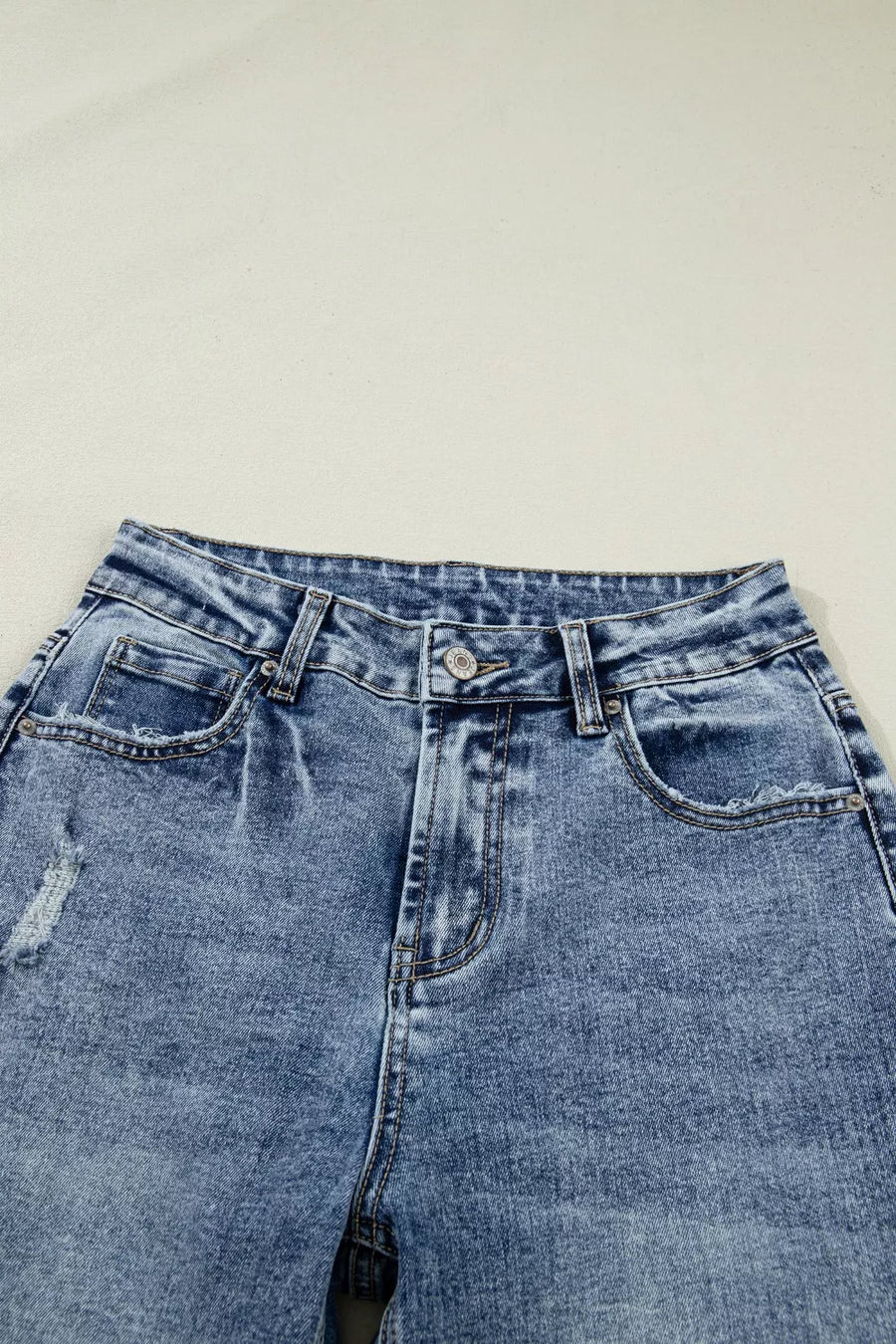 Pair of blue jeans on a light gray background