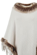 White poncho with brown fur trim on a white background