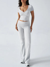 Woman wearing a white outfit on a plain background