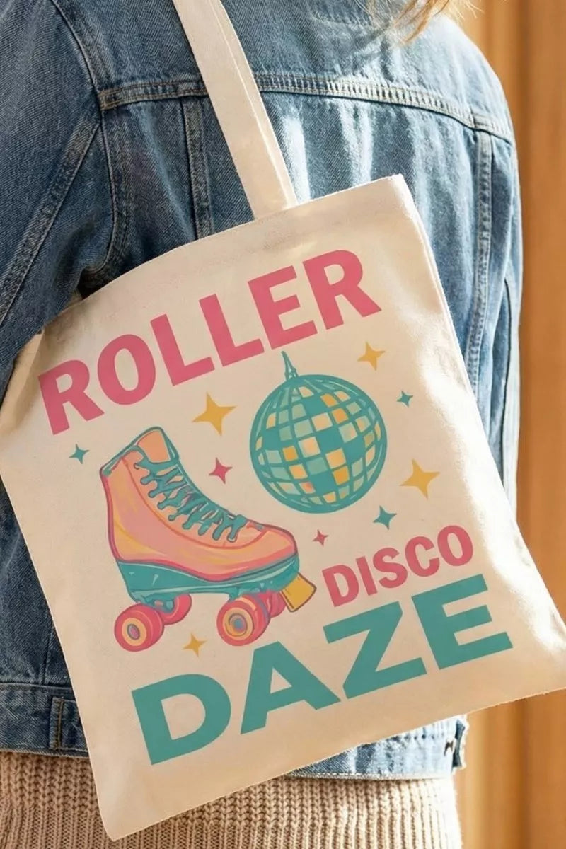 Tote bag with 'Roller Disco Daze' design held by a person wearing a denim jacket.