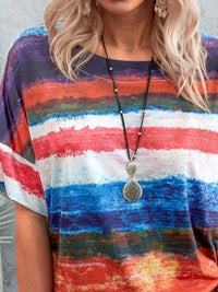 Person wearing a colorful striped shirt with a necklace