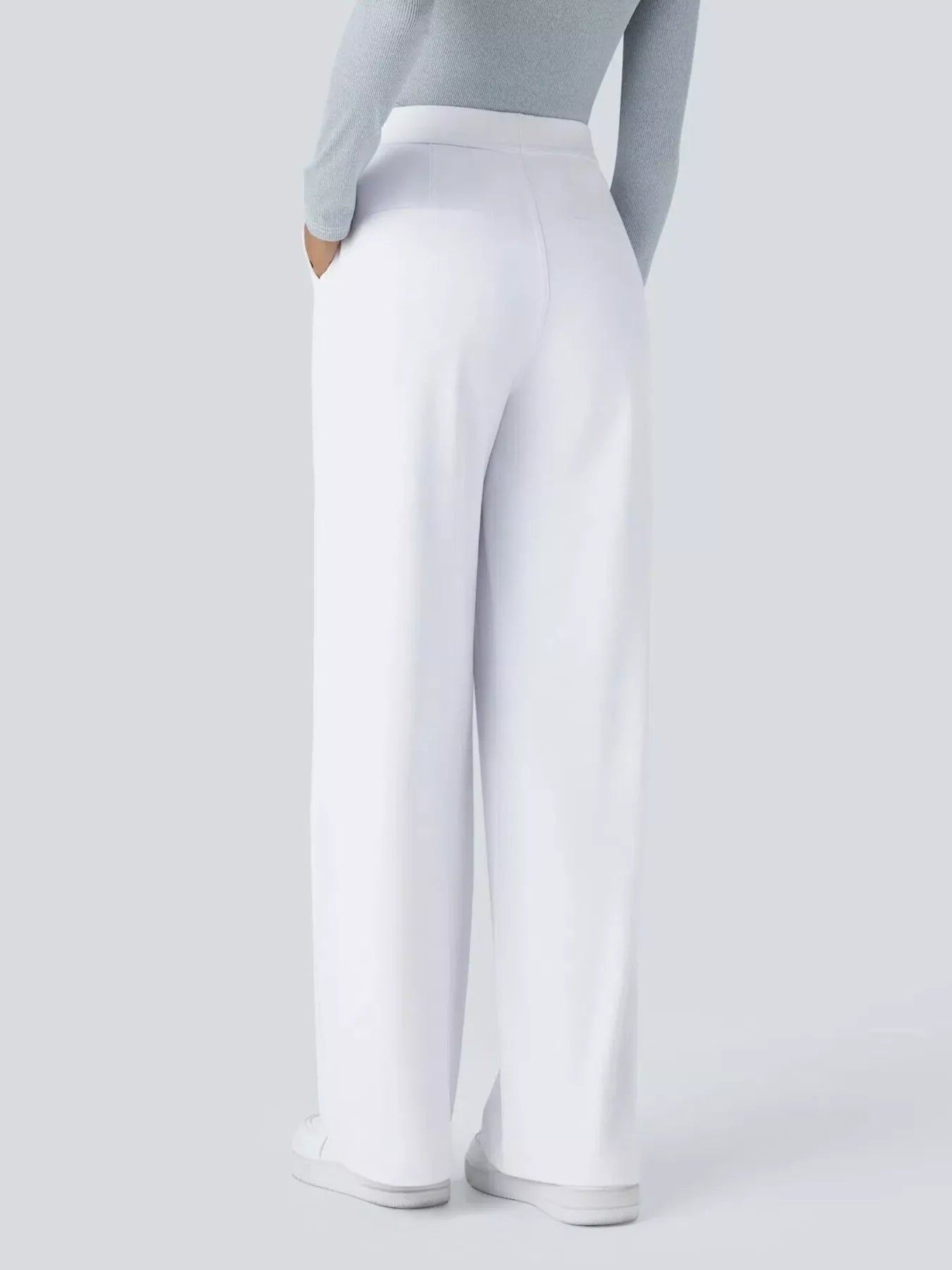 White pants worn by a person on a light gray background