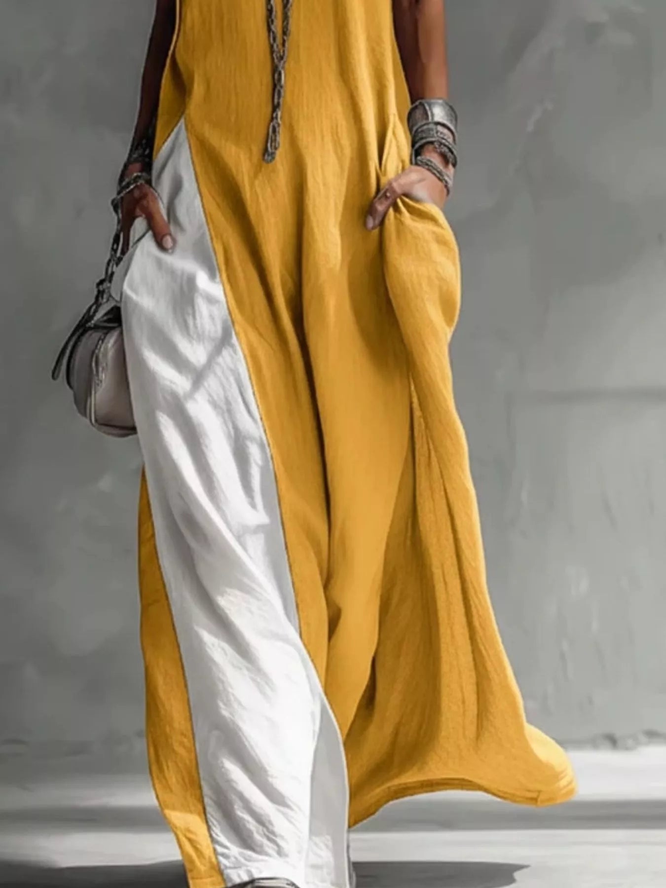 Person wearing a yellow and white outfit with a neutral background
