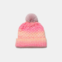 Pink and orange beanie with a pom-pom on a white background