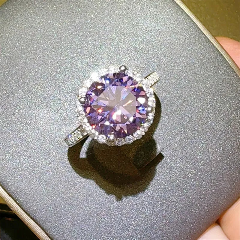 Ring with a purple gemstone on a gray surface