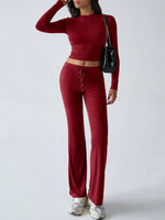 Person wearing a red outfit with a black handbag on a white background