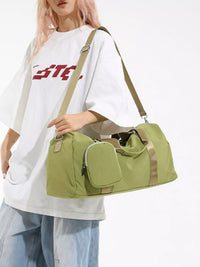 Person holding a green duffel bag with beige straps on a white background