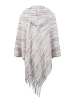 Multicolored poncho with fringe on a white background